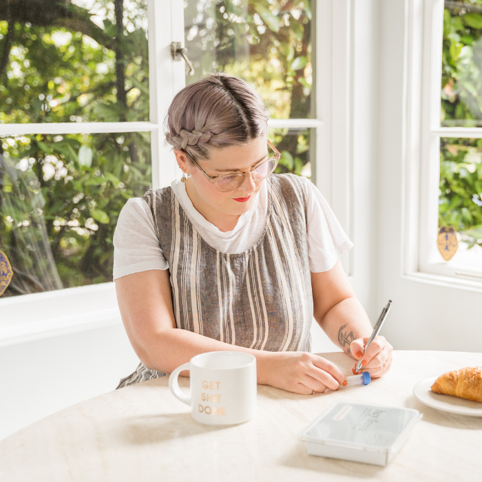 Woman Using a Pen to Write on the Test Tube.