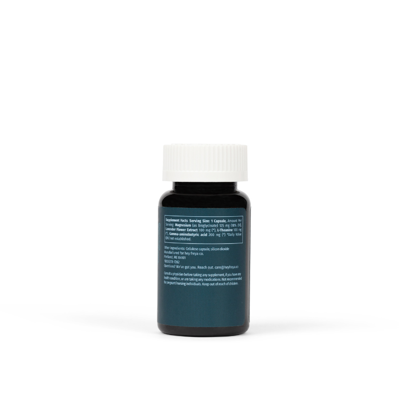 A calming and anxiety reducing supplement for women called CALM, featuring an amber bottle with a navy label that has key minerals and herbs for greater sense of calm, relaxation, and even sleep.