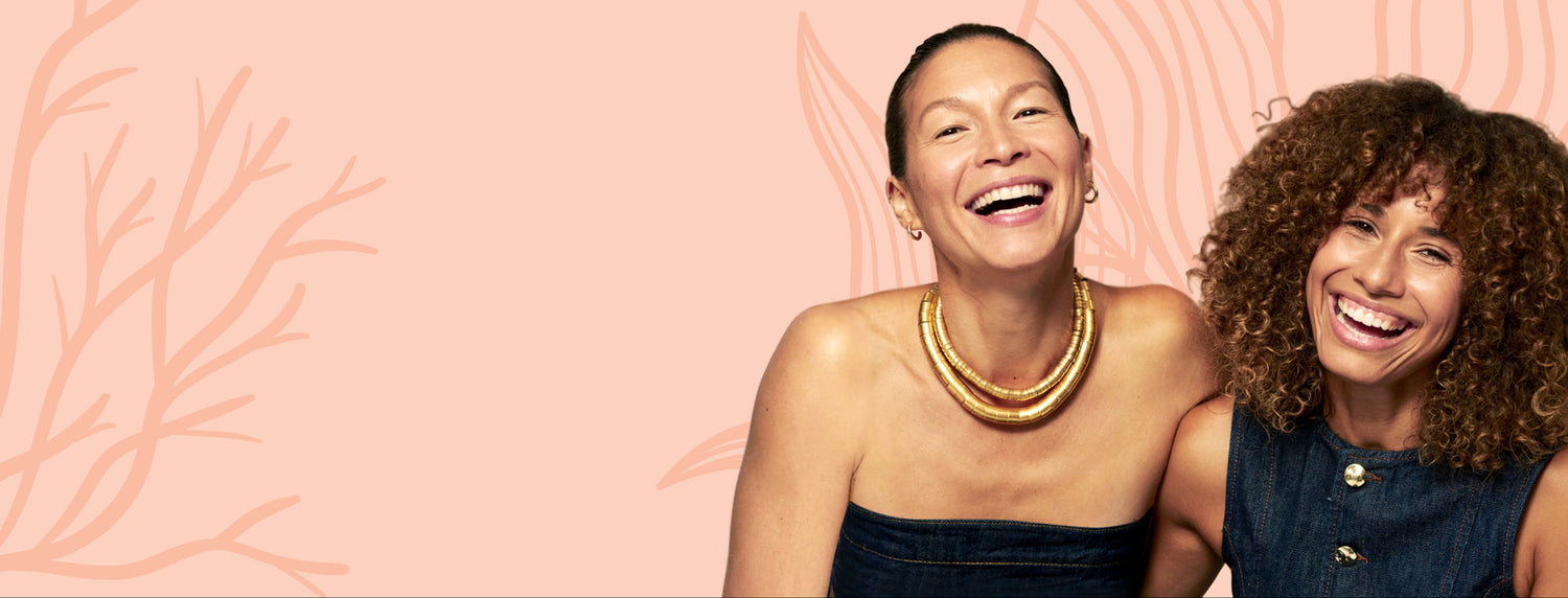 Two women smiling against a pink background with abstract designs